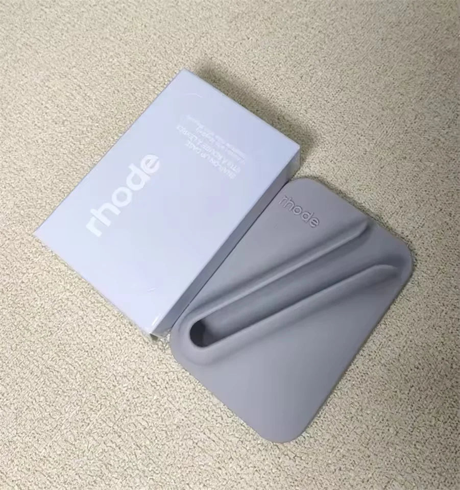 Gray phone grip with 'mode' branding on a beige carpet