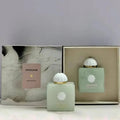 Amouage Existence perfume bottles with packaging on a light gray background