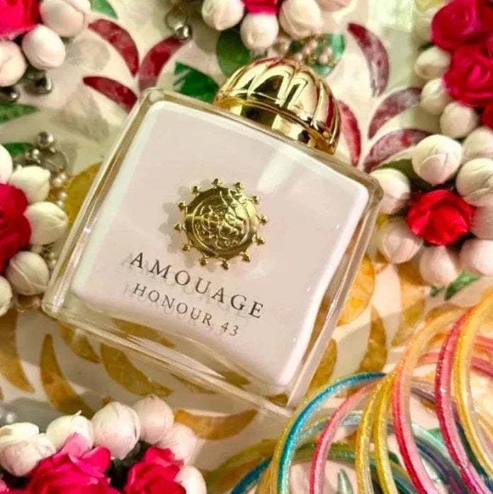 Amouage Honour 43 perfume bottle surrounded by colorful flowers and ribbons