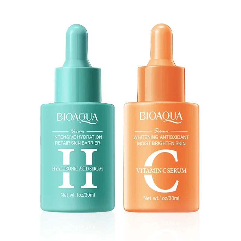 Two Bioaqua serum bottles, one green and one orange, on a white background.