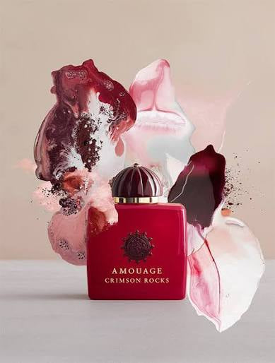 Amouage Crimson Rocks perfume bottle with floral elements on a beige background