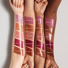 Lipstick swatches on arms with Fenty Beauty branding