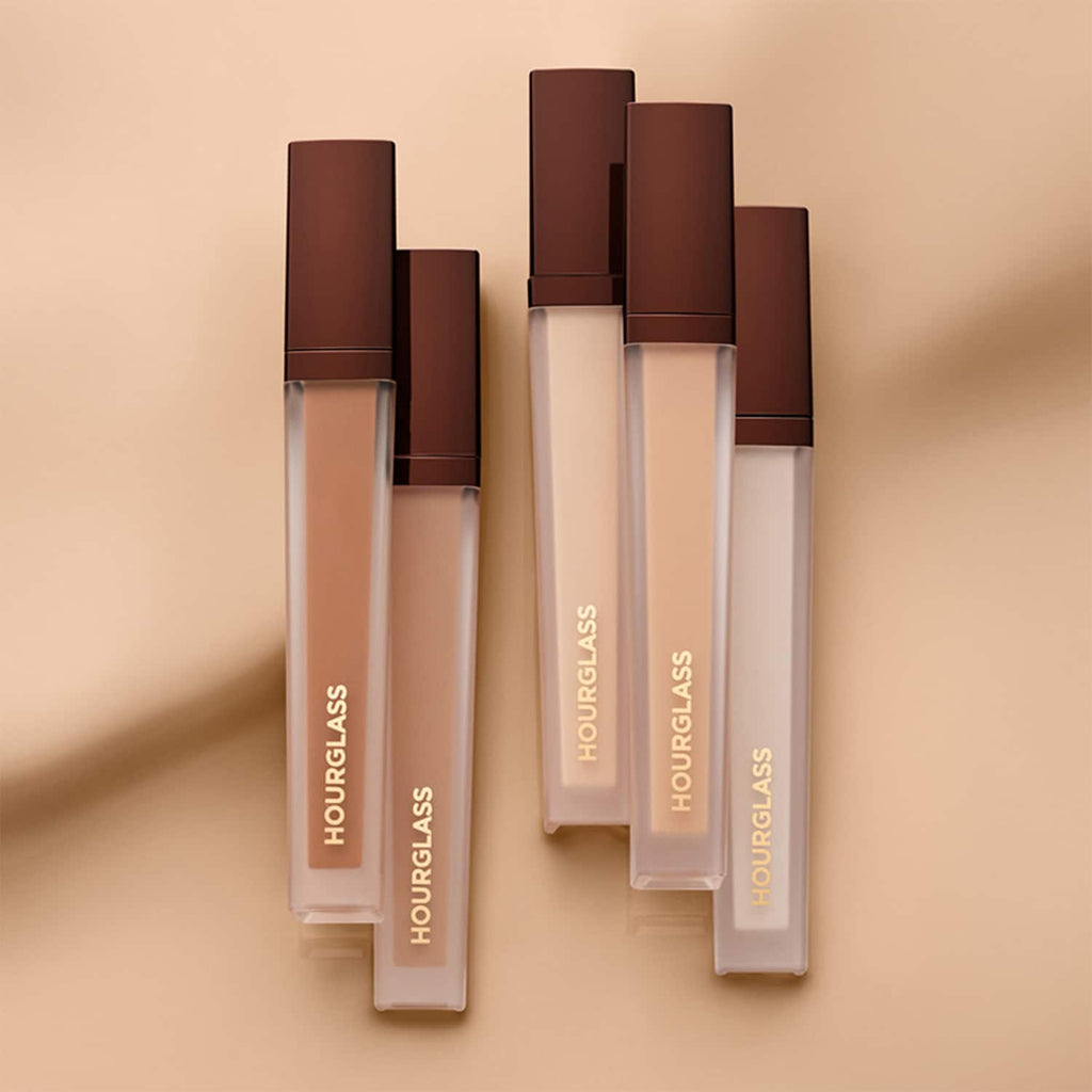 Hourglass concealer bottles on a beige background