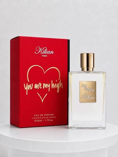 A bottle of Kilian 'You Are My High' eau de parfum next to its red packaging box with gold lettering, displayed on a white pedestal against a light gray background.