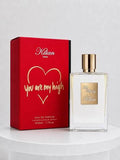 A bottle of Kilian 'You Are My High' eau de parfum next to its red packaging box with gold lettering, displayed on a white pedestal against a light gray background.