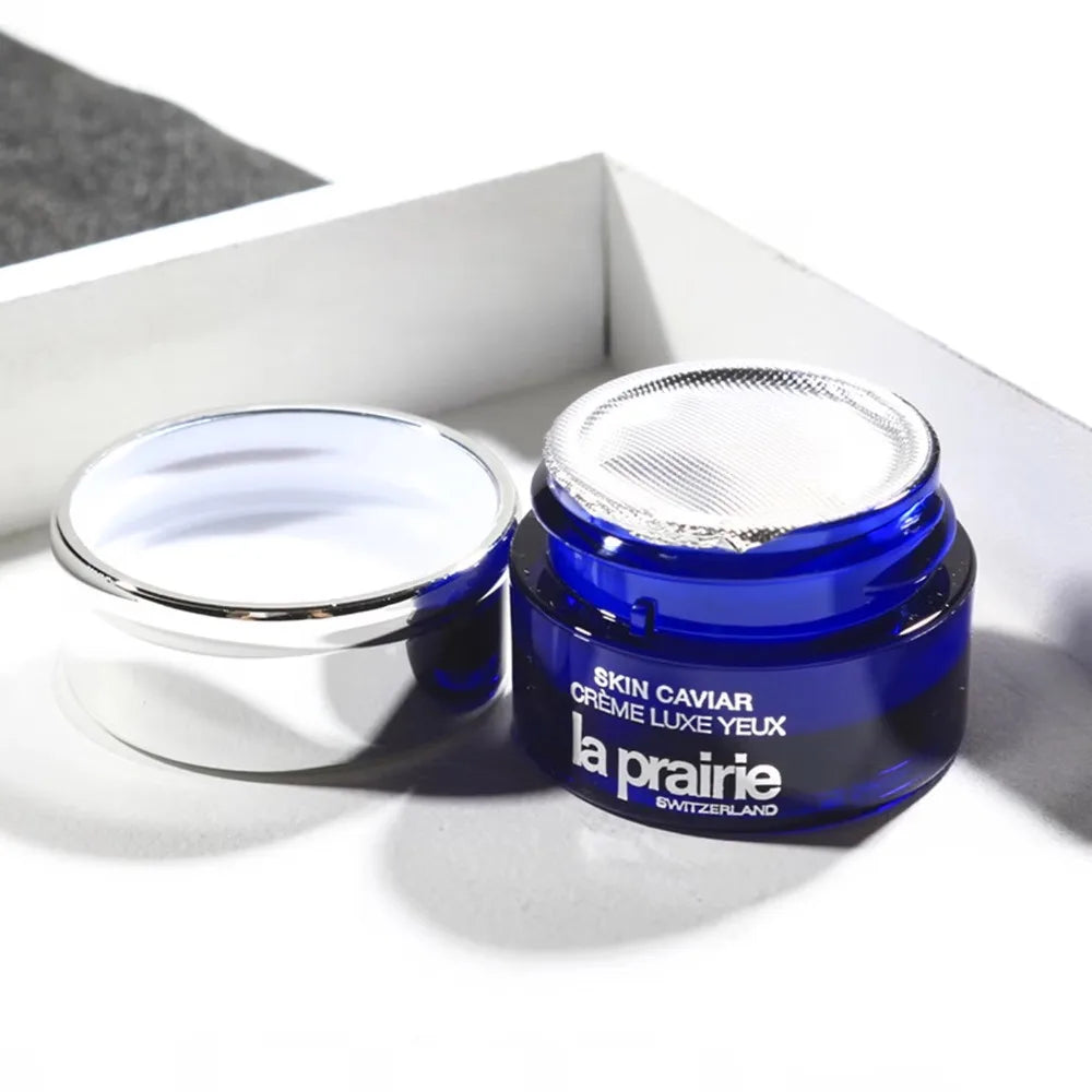 La Prairie eye cream jar with blue lid on a white background