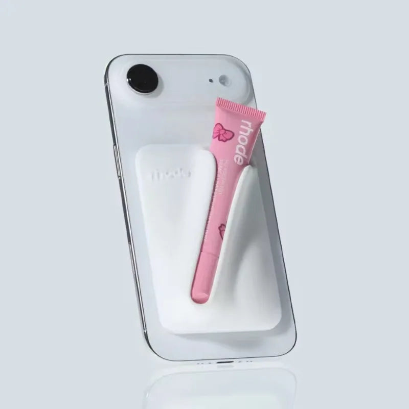 Phone case with pink tube on a light gray background