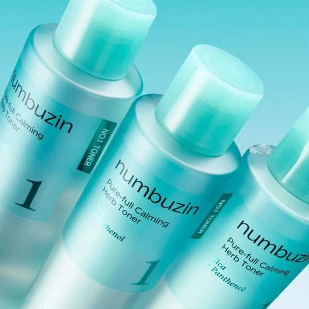Three bottles of Numbuzin Pure-full Calming Herb Toner on a light blue background