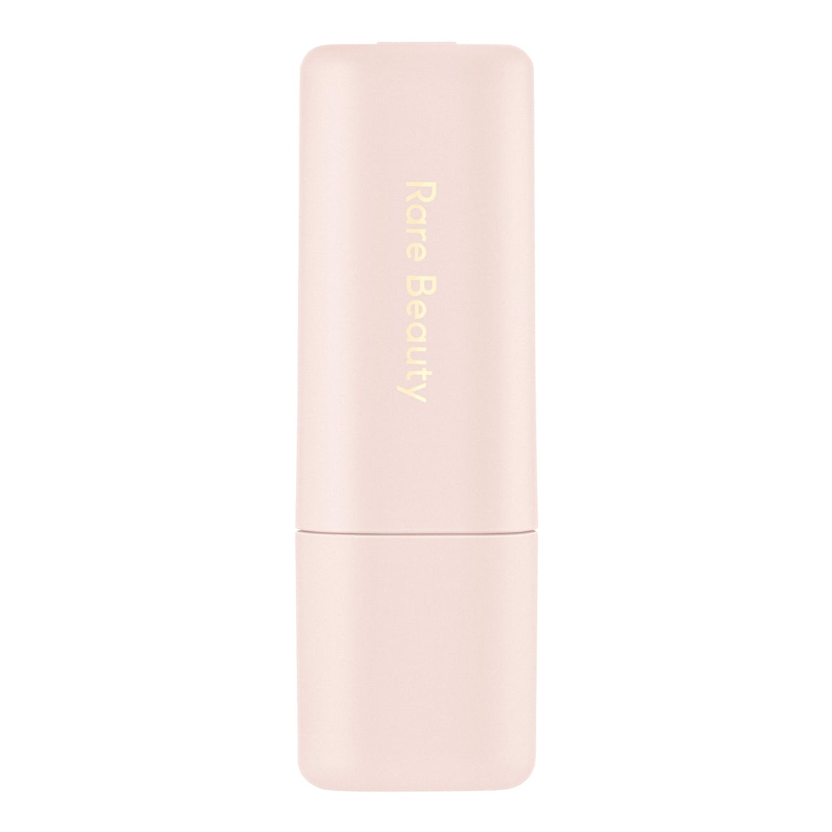 A pale pink Rare Beauty cosmetic stick, likely a lip product, with gold vertical lettering on a clean white background.