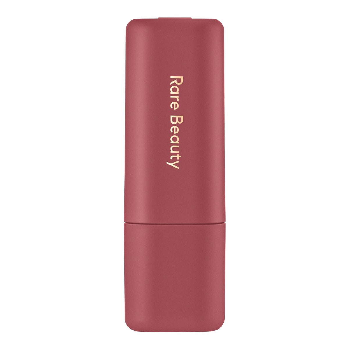 A Rare Beauty lipstick in a dusty rose pink case with gold lettering, shown against a solid white background.