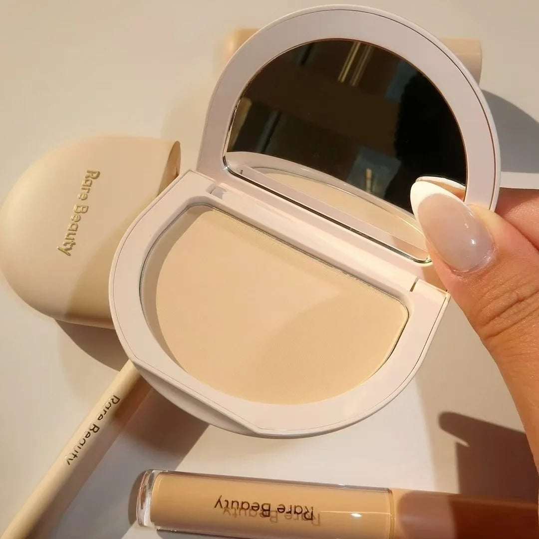 Compact powder with mirror and bottle of foundation from Rare Beauty brand