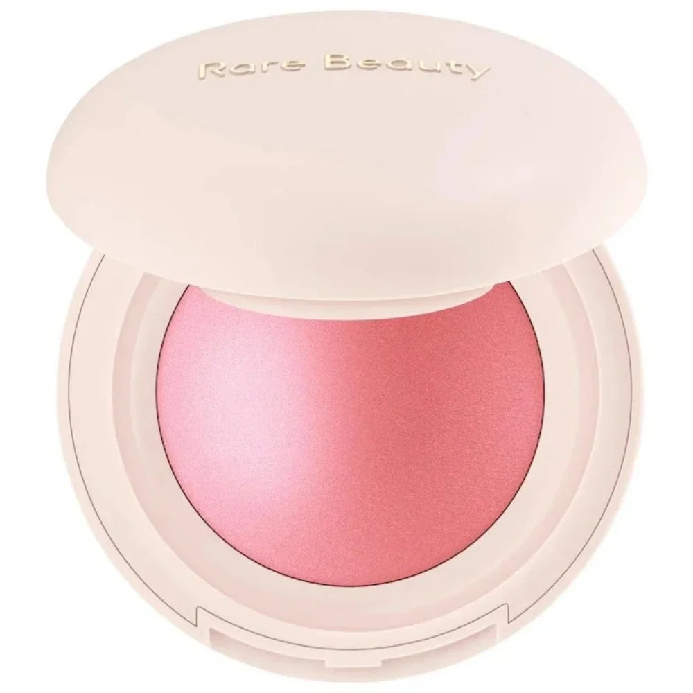 Pink blush in a compact case with 'Rare Beauty' branding on a white background