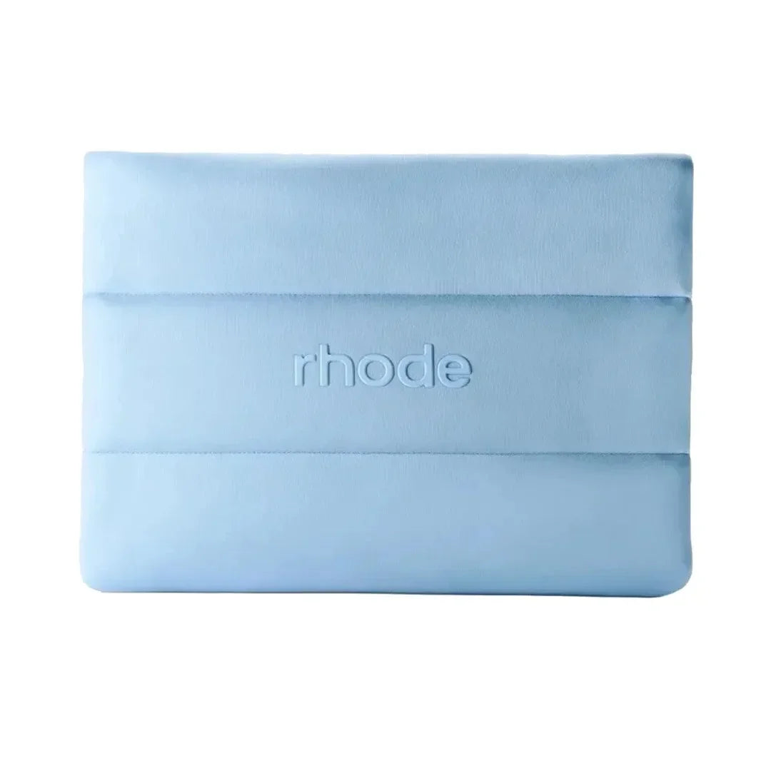Light blue make up bag with 'rhode' branding on a white background