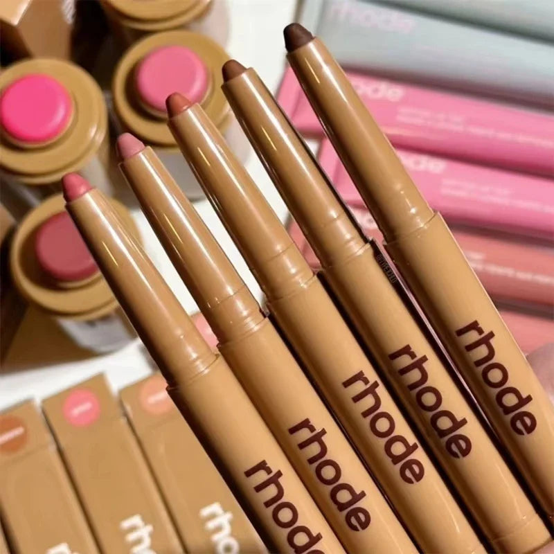 Set of Rhode makeup pencils with pink caps on a white background