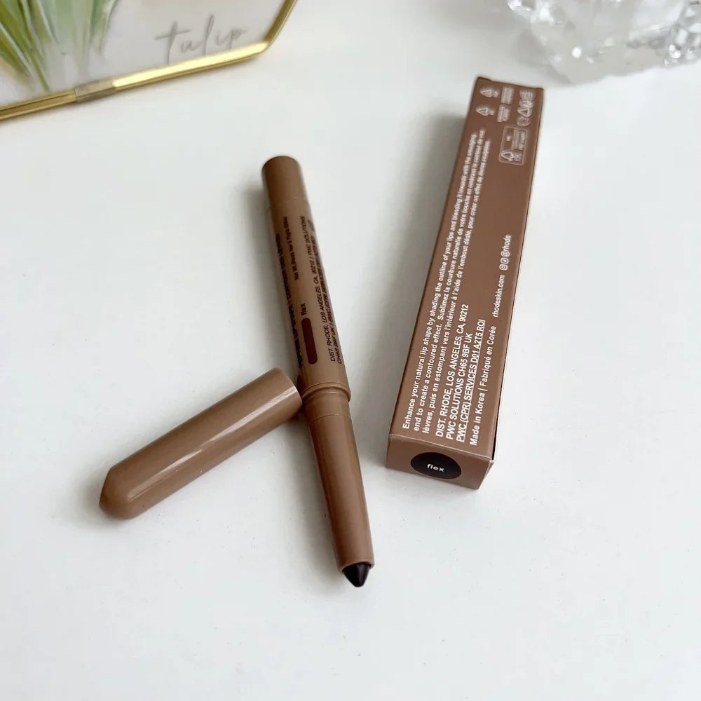 Brown makeup pencil with black cap and packaging on a white surface