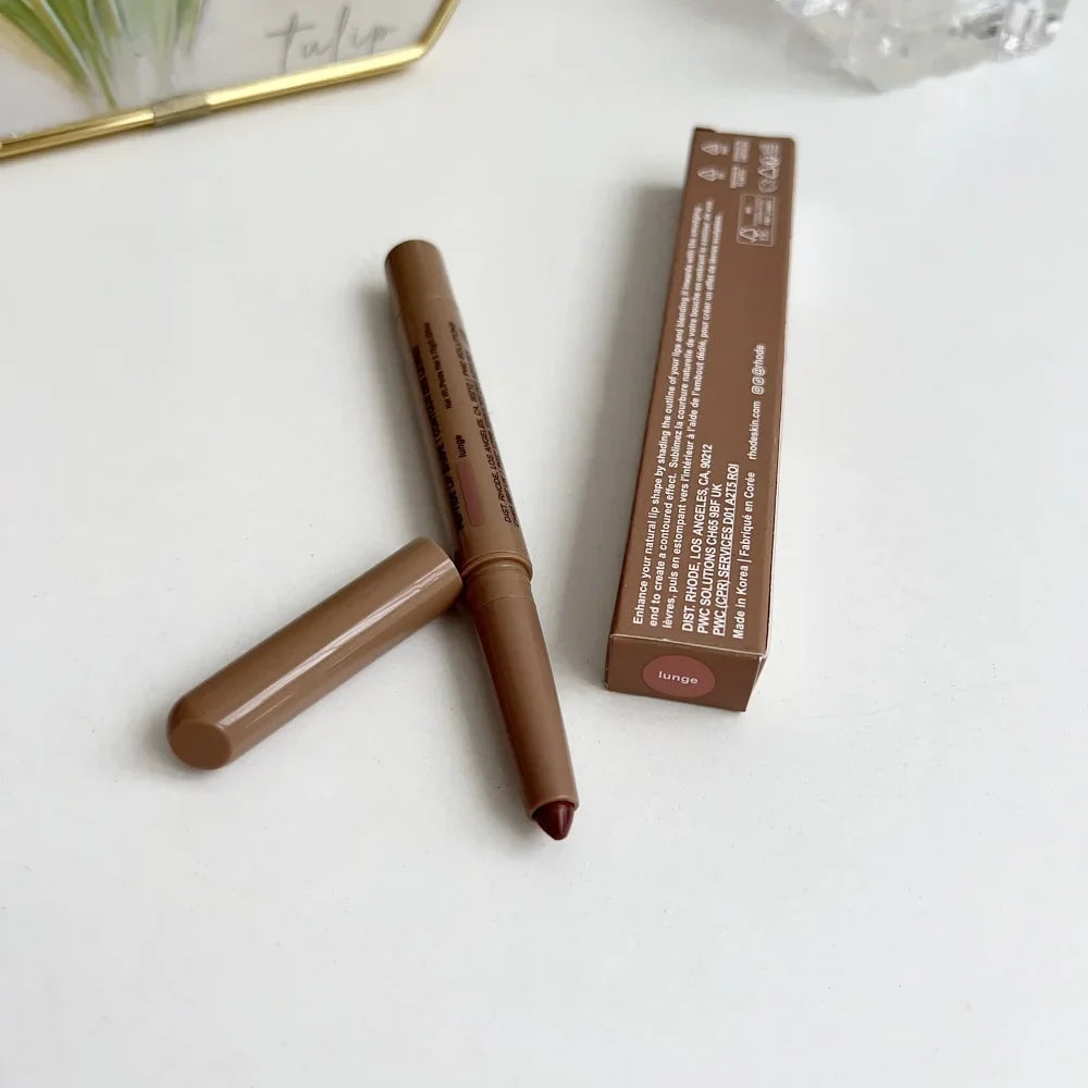 Brown makeup pencil with packaging on a white surface