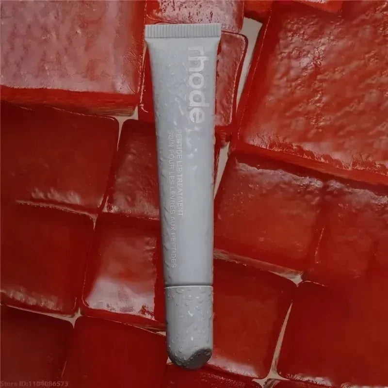 Tube of 'rhode' skincare product on a red textured background