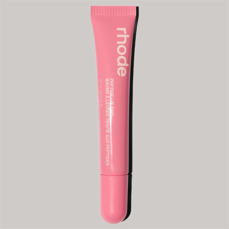 Pink lip balm tube with 'rhode' branding on a gray background